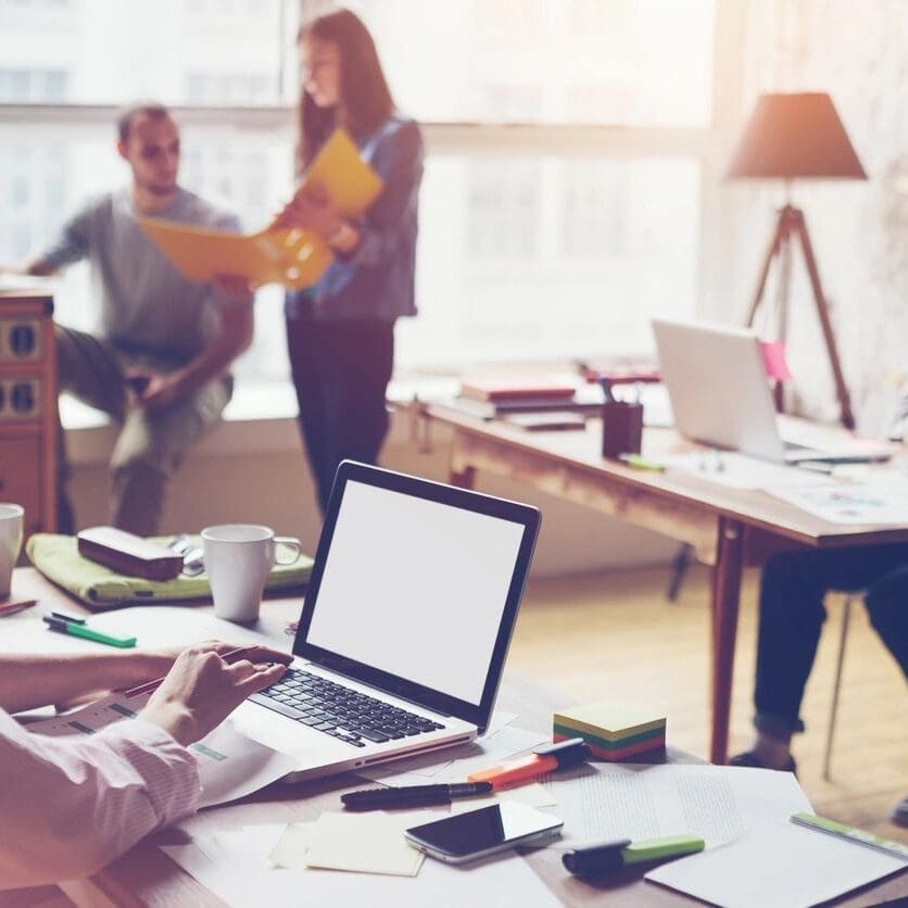 A group of people in an office setting.